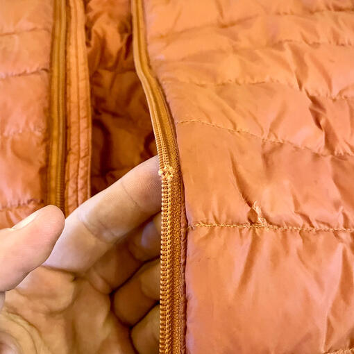 Before - Broken zip and jacket hole. Before - Broken zip and jacket hole.